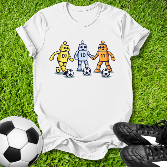 White t-shirt with robot design on grass with soccer ball and shoes