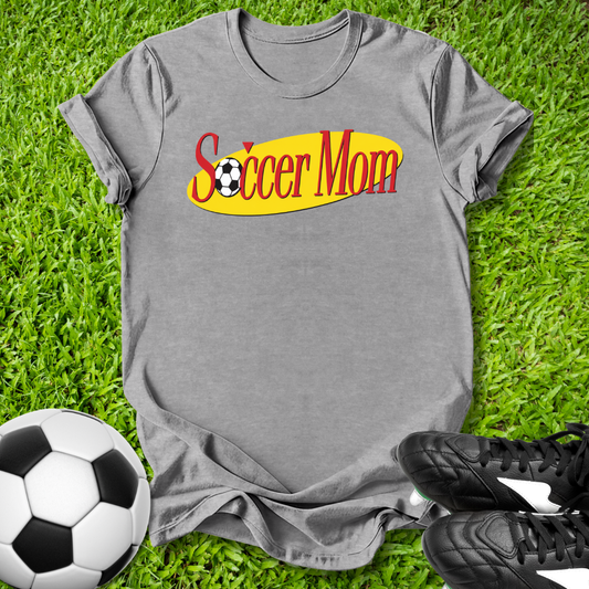Gray t-shirt with 'Soccer Mom' text on grass with soccer ball and shoes