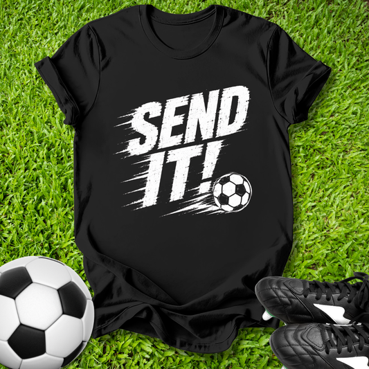 Black t-shirt with 'SEND IT!' text and soccer ball on grass with soccer ball and shoes.