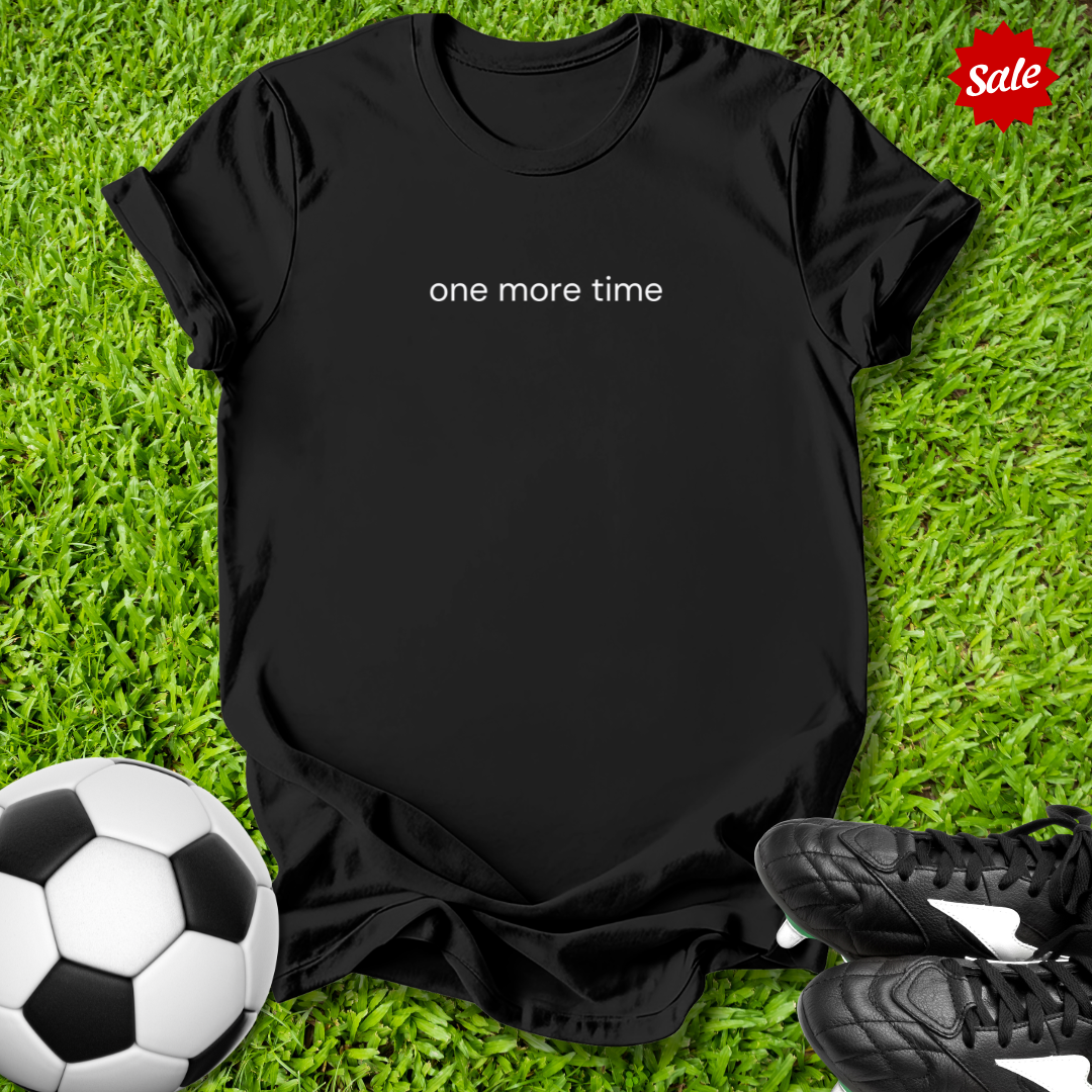 Black t-shirt with 'one more time' text on grass with soccer ball and shoes, sale label.