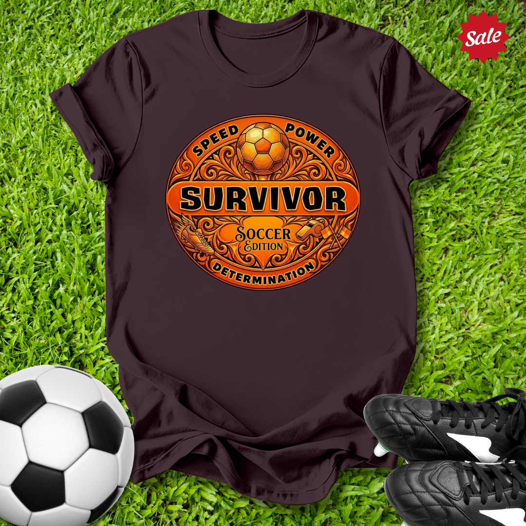 Brown t-shirt with Survivor soccer-themed design on grass with soccer ball and shoes