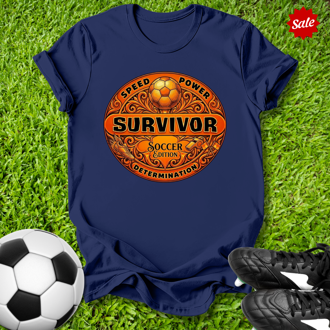 Navy blue t-shirt with 'Survivor Soccer Edition' design on grass with soccer ball and shoes.