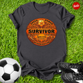 Black t-shirt with 'Survivor Soccer Edition' design on grass with soccer ball and shoes.