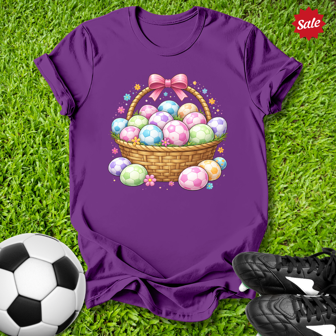 Purple t-shirt with Easter egg design on grass with soccer ball and shoes