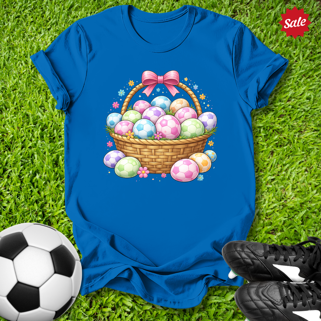 Blue t-shirt with Easter basket design on grass with soccer ball and shoes