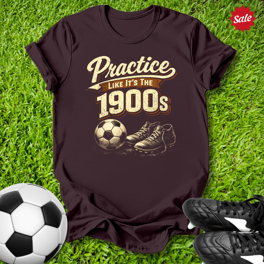 Brown t-shirt with vintage soccer design on grass with soccer ball and shoes