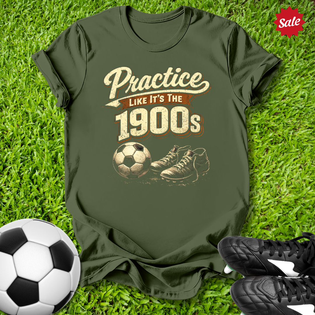 Green t-shirt with vintage soccer design on grass with soccer ball and shoes