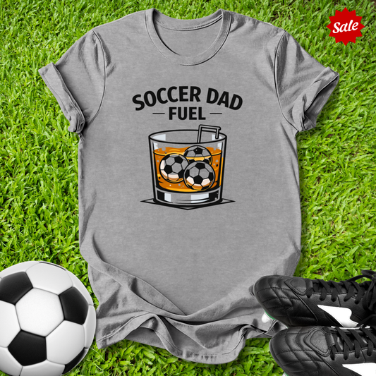 Gray t-shirt with 'Soccer Dad Fuel' graphic on grass with soccer ball and cleats