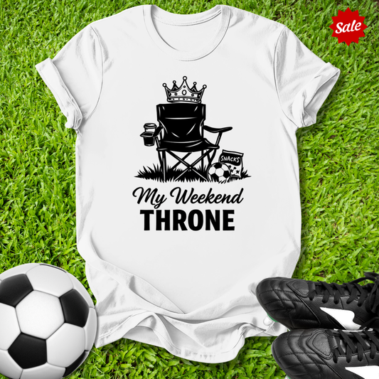 White t-shirt with 'My Weekend Throne' graphic on grass with soccer ball and shoes