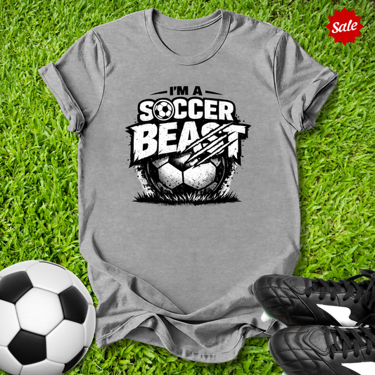 Gray t-shirt with 'Soccer Beast' graphic on grass with soccer ball and shoes