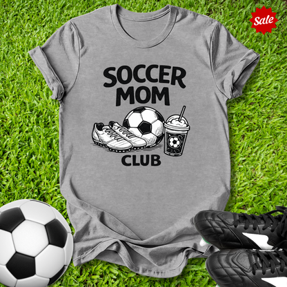 Gray Pink t-shirt with 'Soccer Mom Club' text on grass with soccer ball and shoes