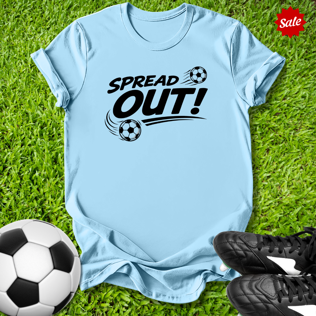 Light blue  t-shirt with 'Spread Out!' text on grass with soccer ball and shoes