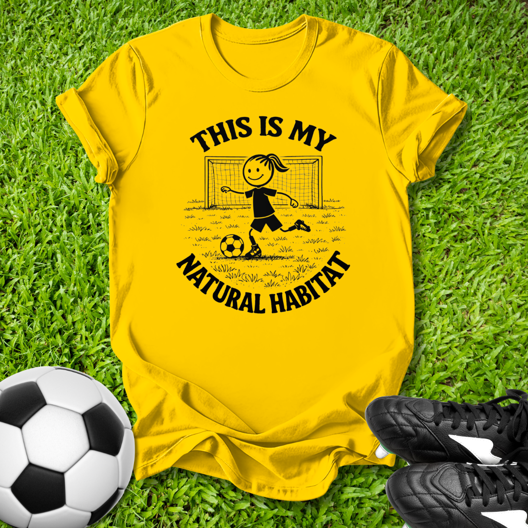 Yellow t-shirt with a soccer-themed  this is my natural habitat design on grass with a soccer ball and shoes.