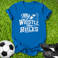 Blue t-shirt with 'My Whistle My Rules' text on grass with soccer ball and shoes