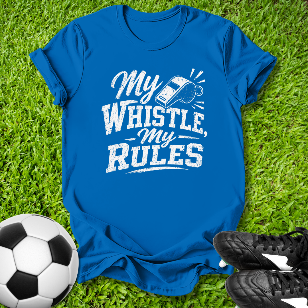 Blue t-shirt with 'My Whistle My Rules' text on grass with soccer ball and shoes