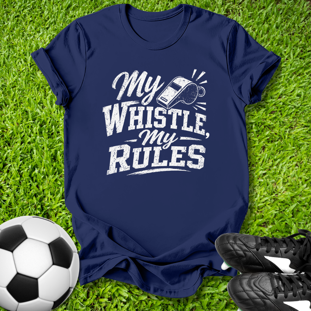 Navy blue t-shirt with 'My Whistle, My Rules' text on grass with soccer ball and shoes.