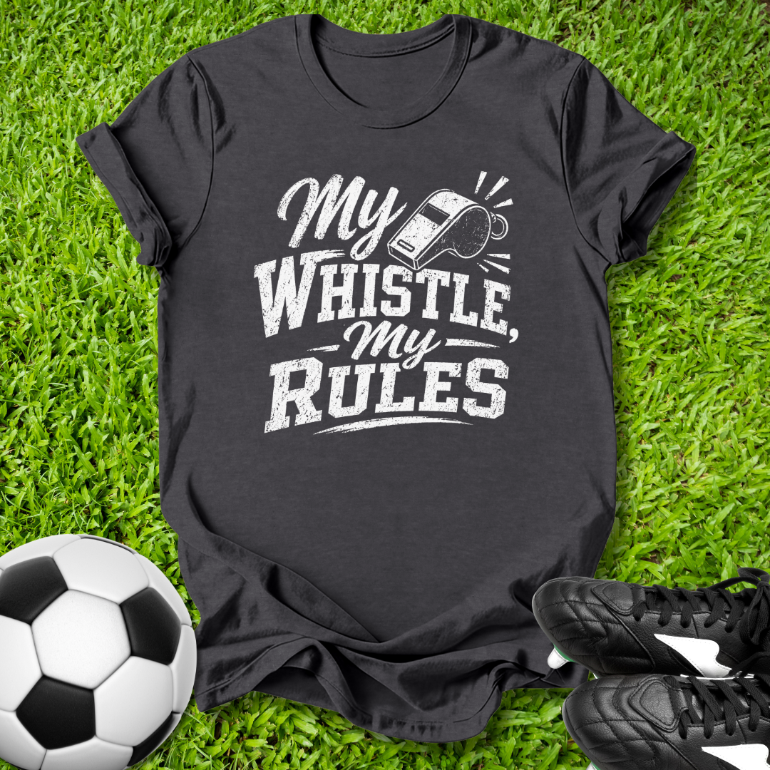 Black t-shirt with 'My Whistle, My Rules' text on grass with soccer ball and shoes