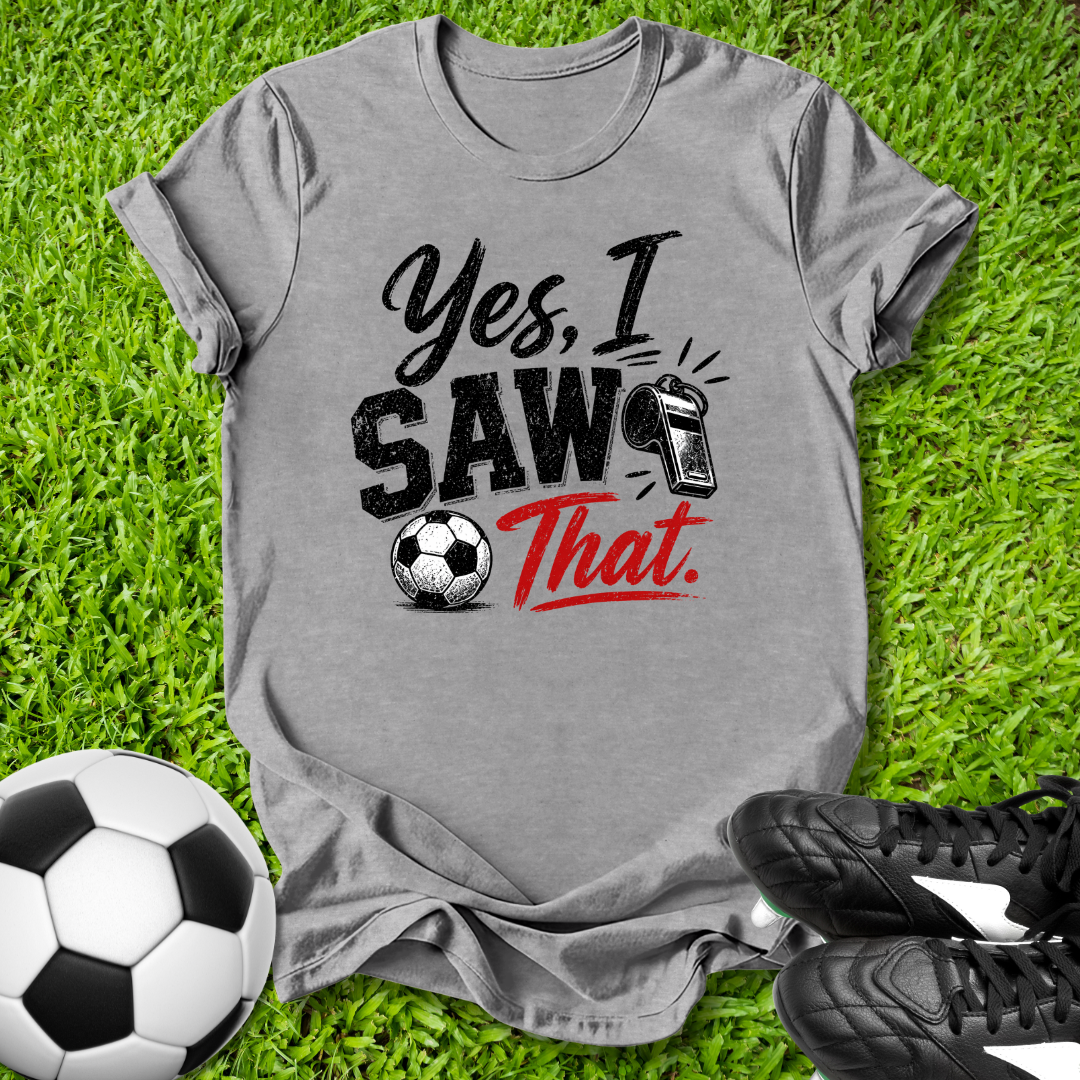 Gray t-shirt with 'Yes, I Saw That' text on grass with soccer ball and shoes