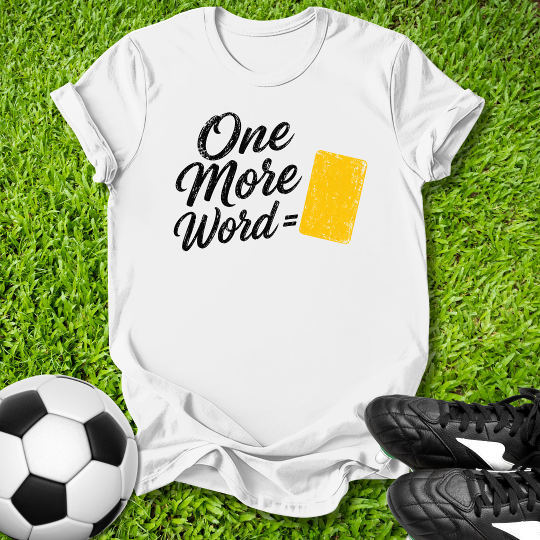 White t-shirt with 'One More Word' text on grass with soccer ball and shoes