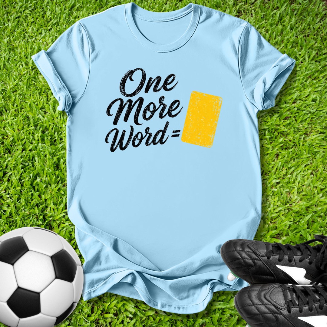 Light blue t-shirt with 'One More Word' text on grass with soccer ball and shoes
