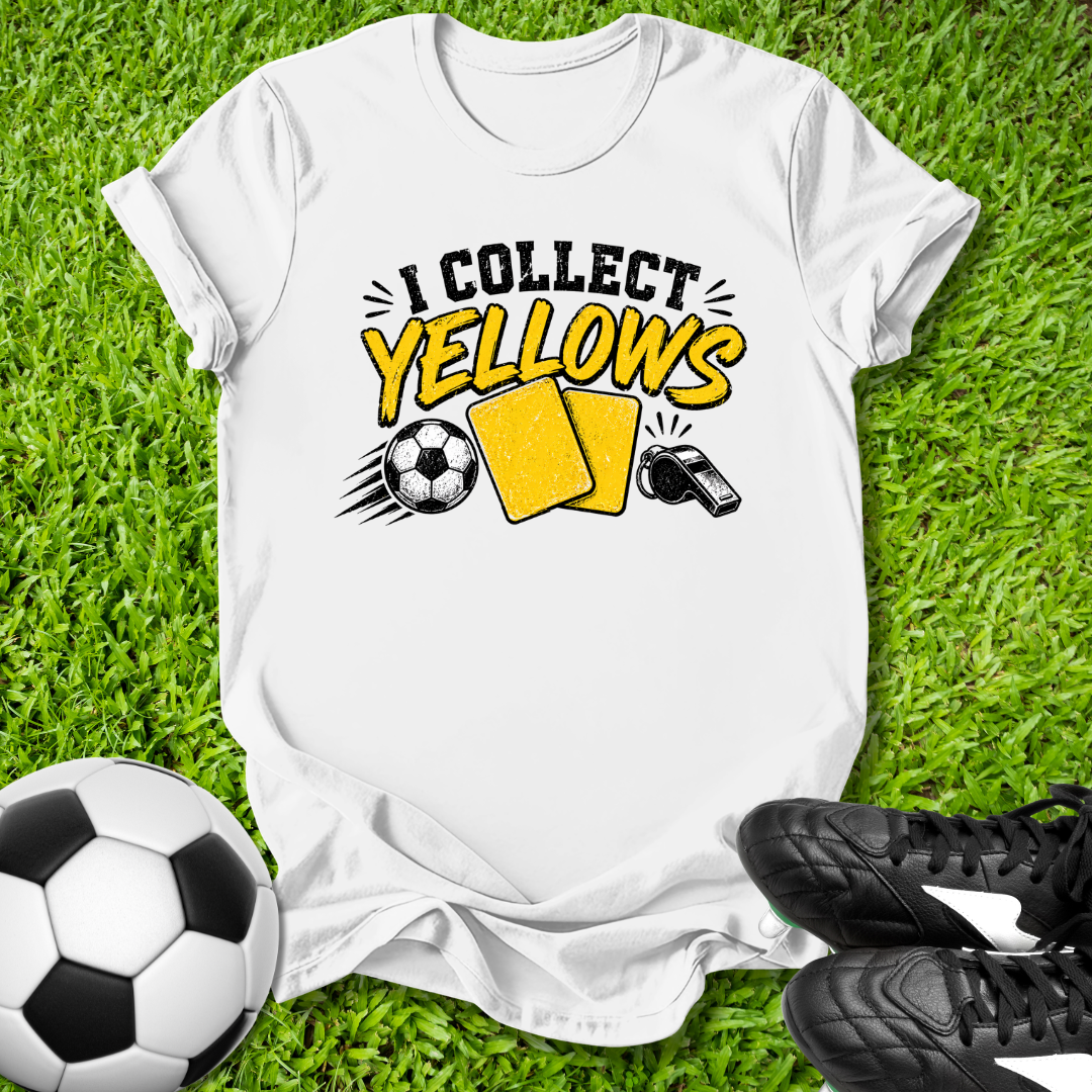 White t-shirt with 'I Collect yellows' design on grass with soccer ball and shoes.