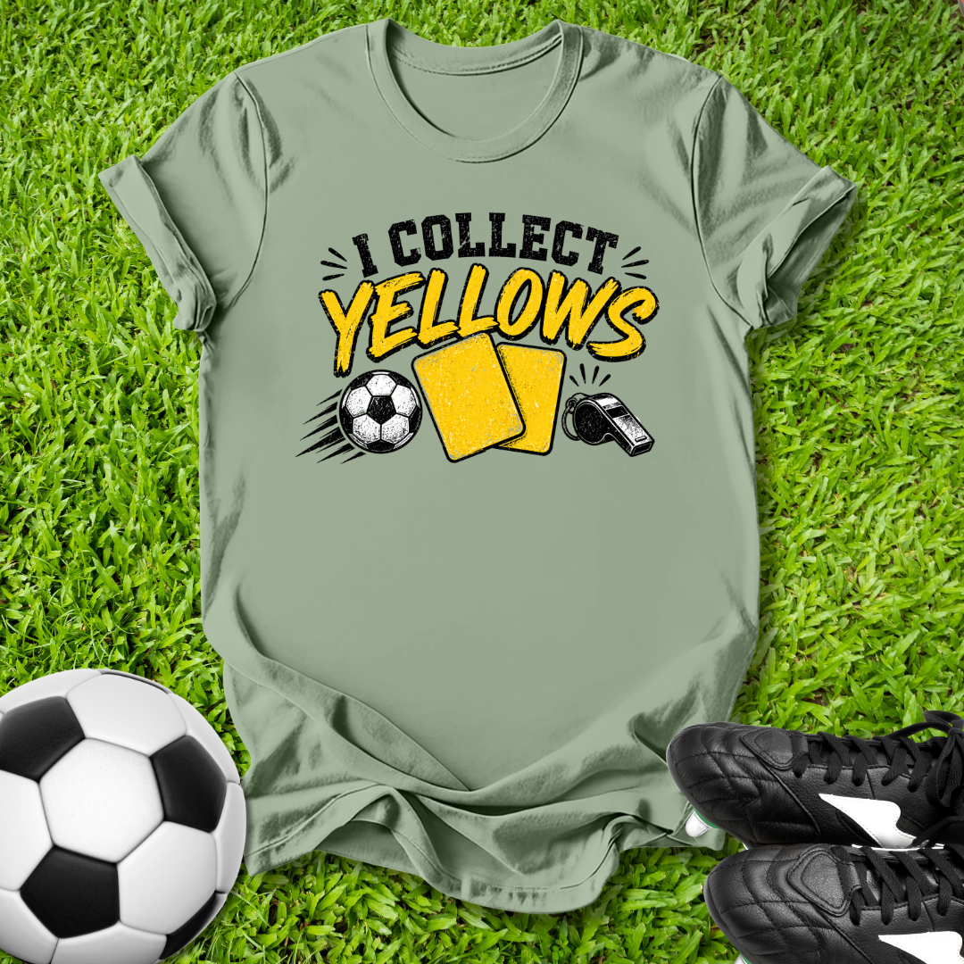 Green t-shirt with 'I Collect yellows' design on grass with soccer ball and shoes.