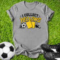 Gray t-shirt with 'I Collect yellows' design on grass with soccer ball and shoes.