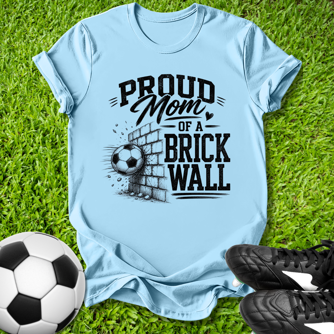 Light blue shirt with a soccer ball that says in white text Proud Soccer Mom of a Brick Wall