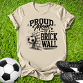 Beige shirt with a soccer ball that says in white text Proud Soccer Mom of a Brick Wall