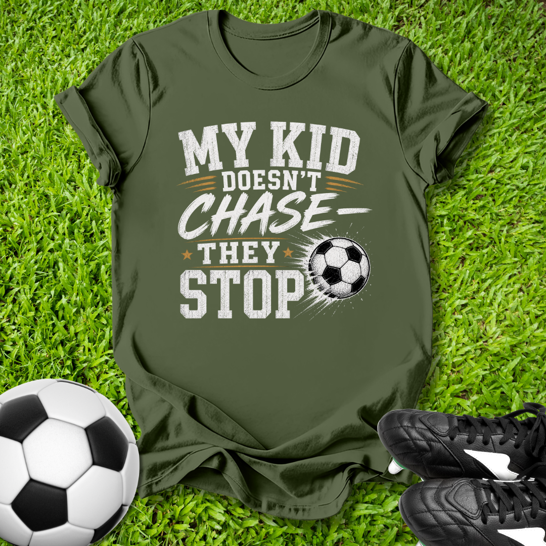 Green  shirt with a soccer ball that says in white text y Kid Doesn't Chase--They stop.