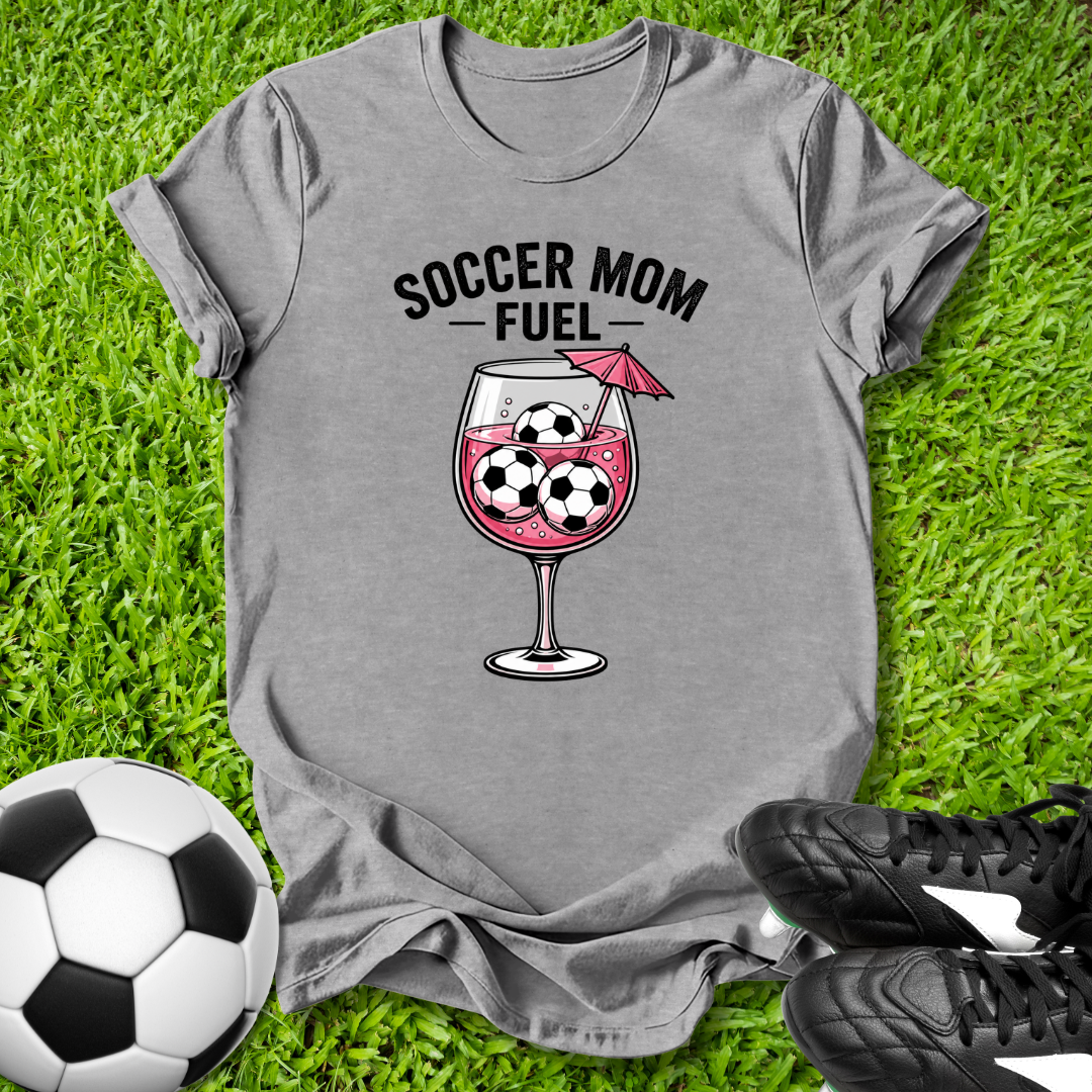 Gray t-shirt with 'Soccer Mom Fuel' graphic on grass with soccer ball and shoes.