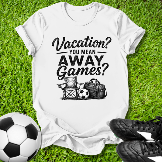 White t-shirt with 'Vacation? You Mean Away Games?' text and graphics on grass with soccer ball and cleats.