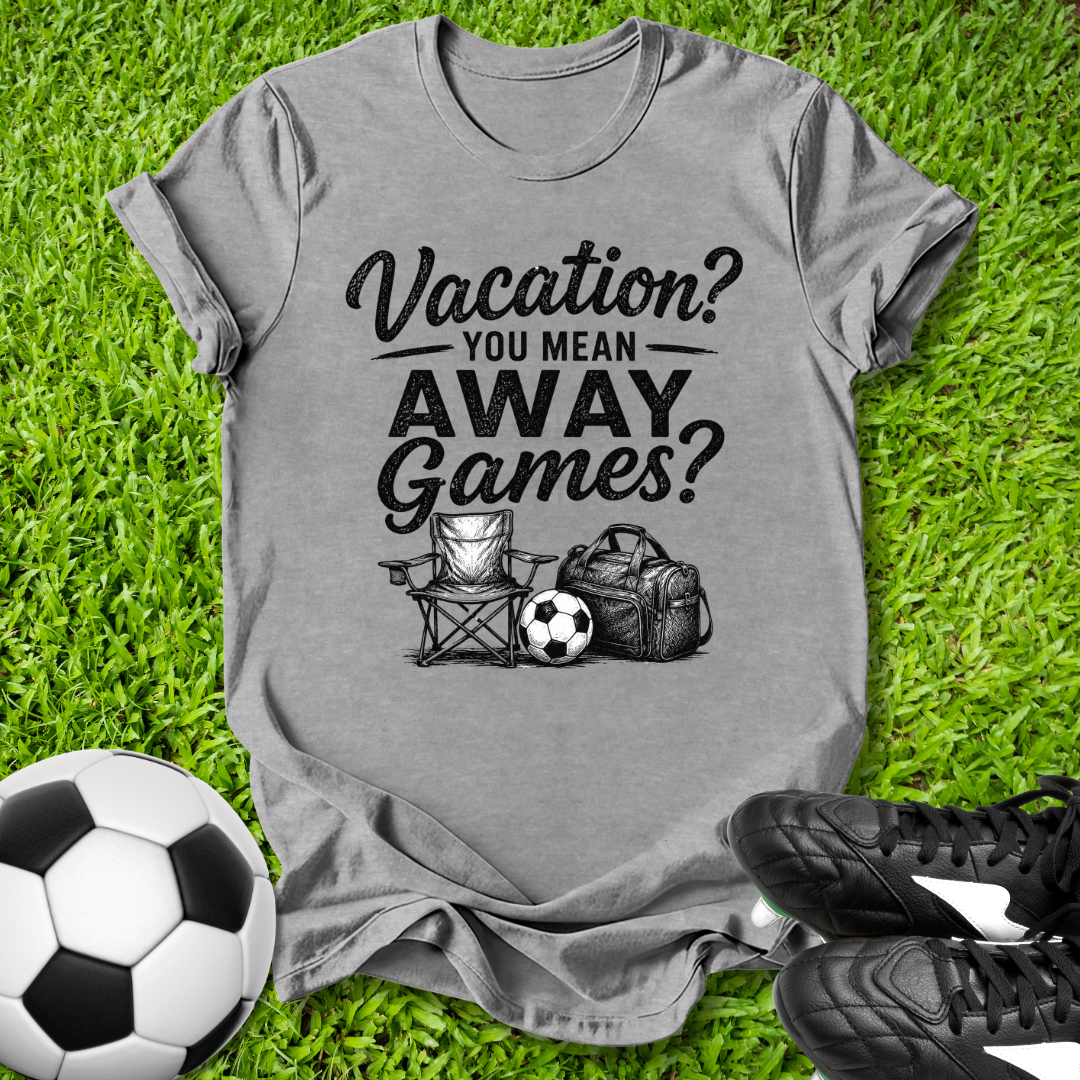 Gray t-shirt with 'Vacation? You mean AWAY Games?' text on grass with soccer ball and cleats.