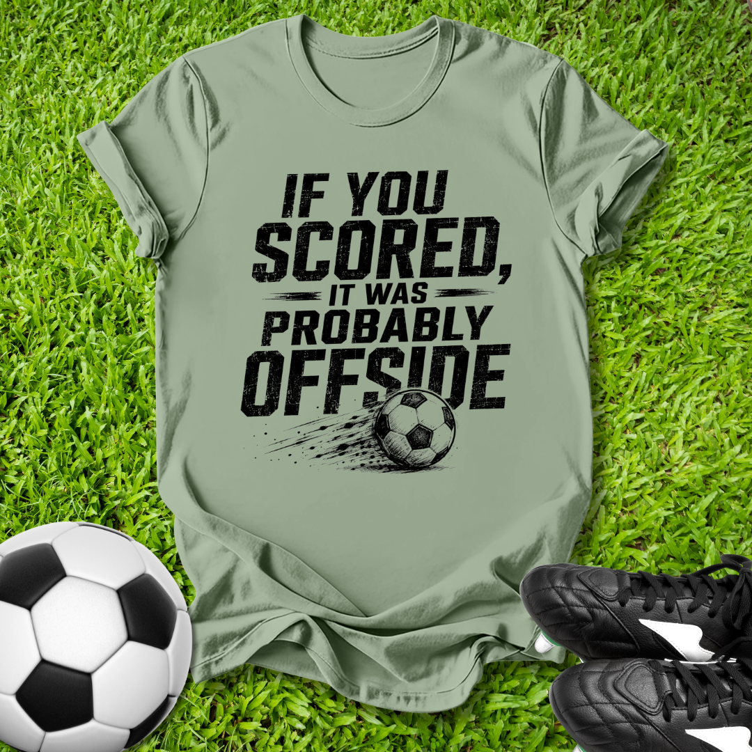 offside Soccer-themed t-shirt with humorous text on grass with soccer ball and shoes.
