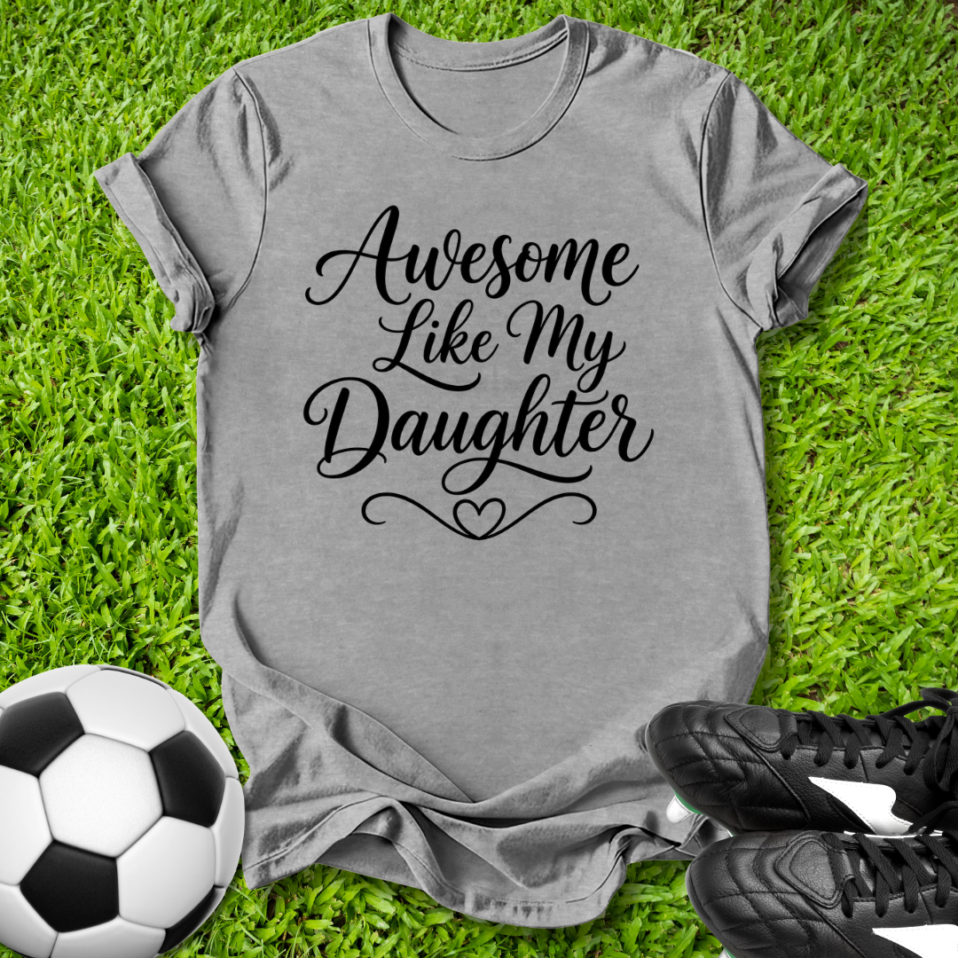 Gray t-shirt with 'Awesome Like My Daughter' text on grass with soccer ball and shoes.