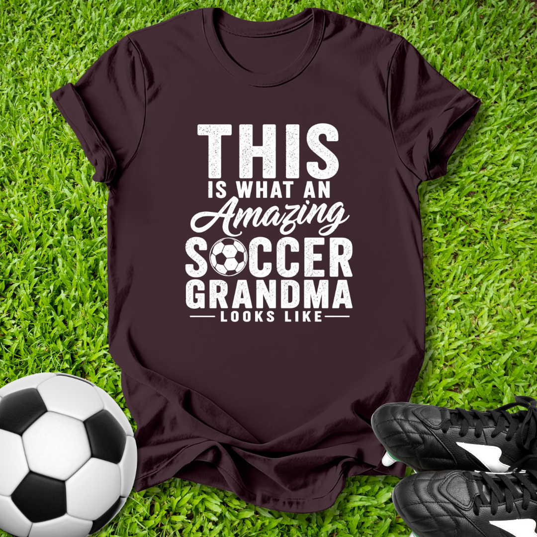 Brown t-shirt with 'Amazing Soccer Grandma' text on grass with soccer ball and shoes