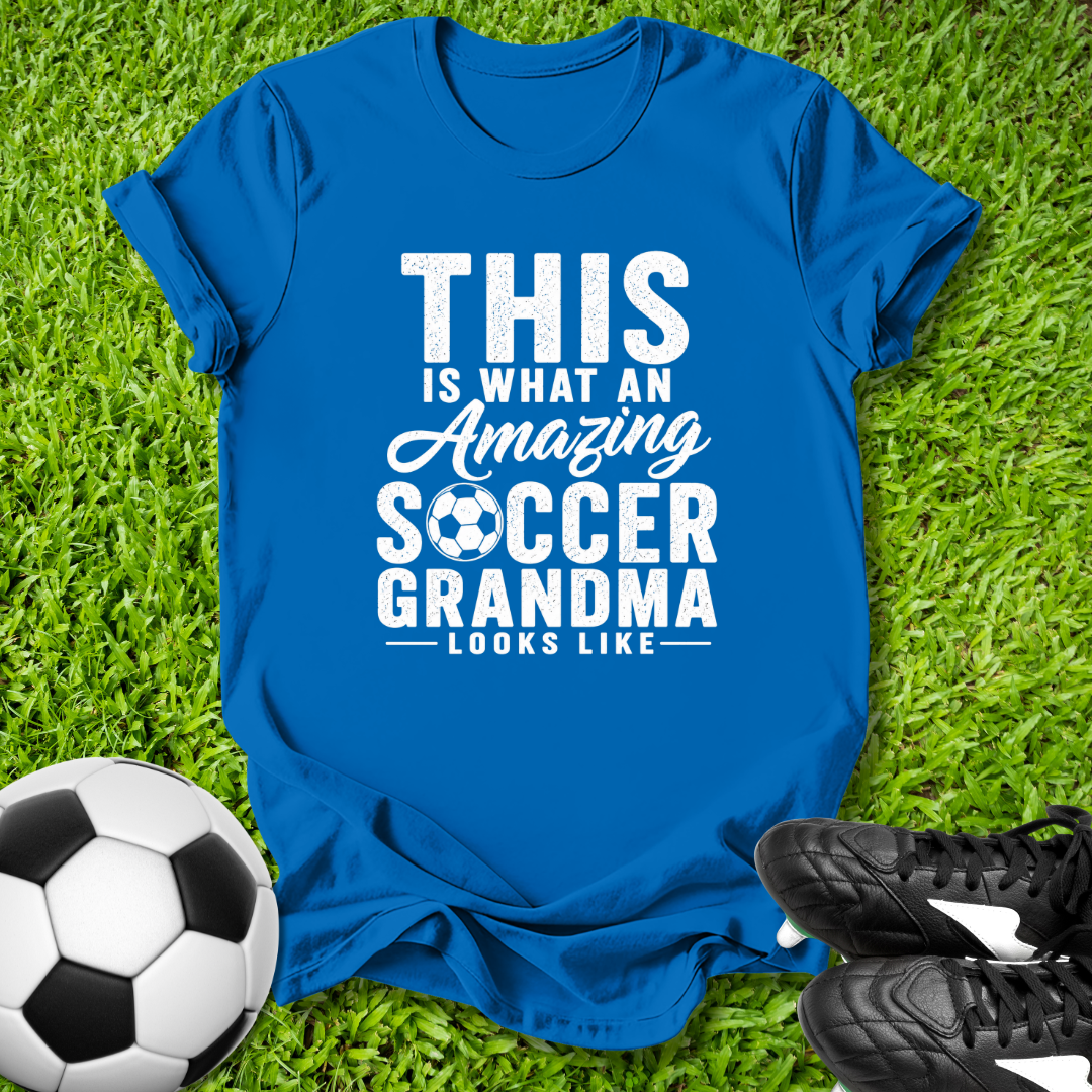 Blue t-shirt with 'Amazing Soccer Grandma' text on grass with soccer ball and shoes
