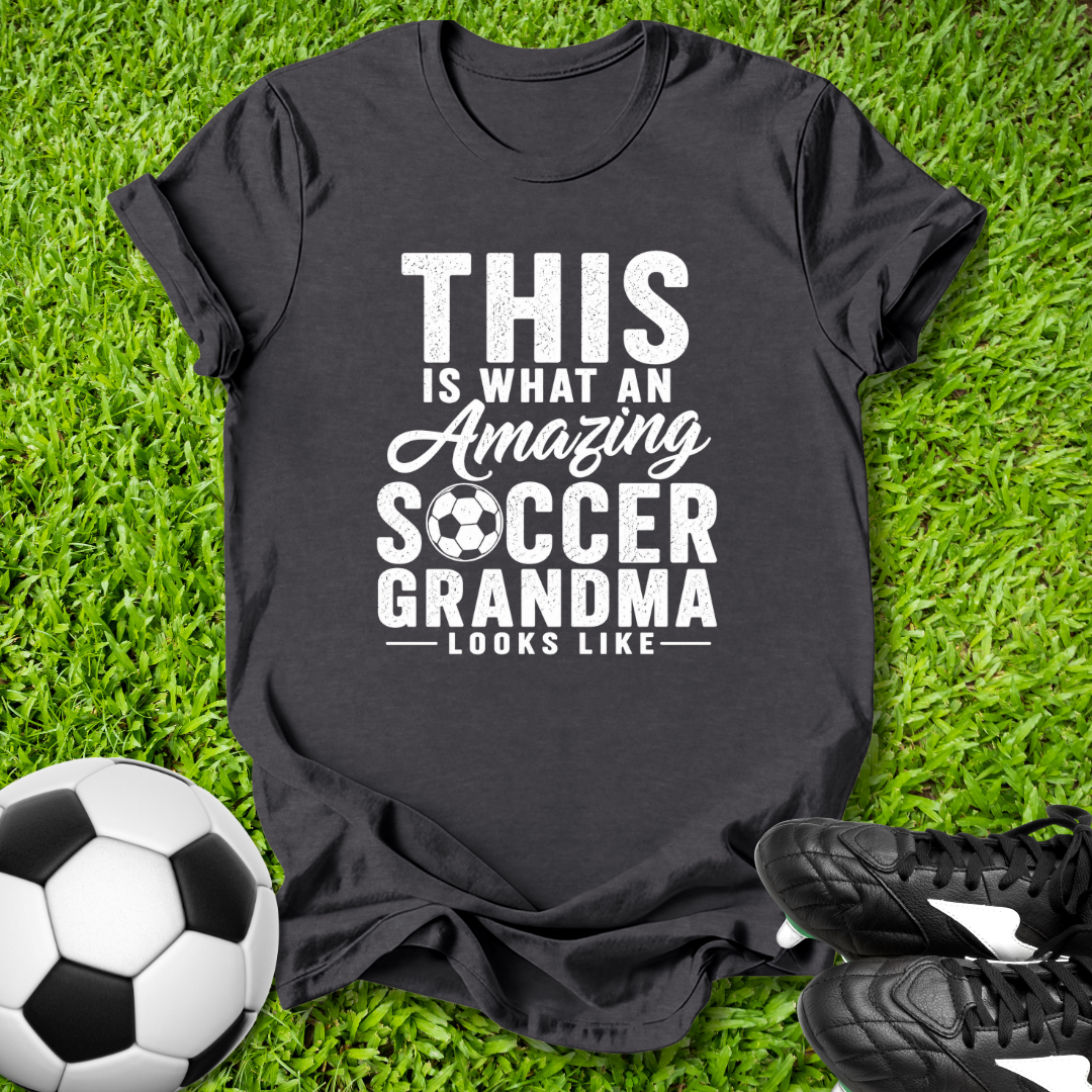 Black t-shirt with 'Amazing Soccer Grandma' text on grass with soccer ball and shoes
