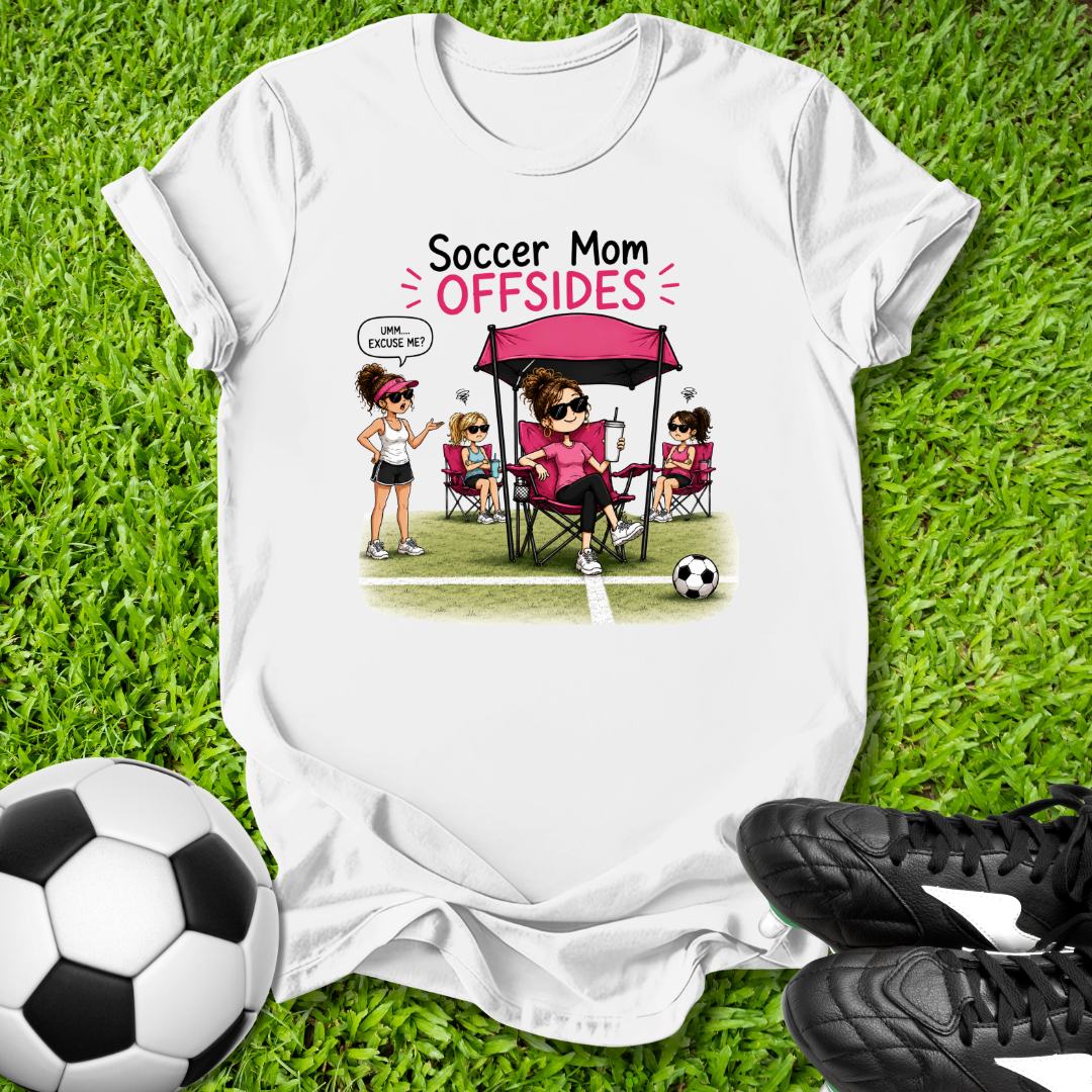 White t-shirt with 'Soccer Mom OFFSIDES' graphic on grass with soccer ball and shoes.