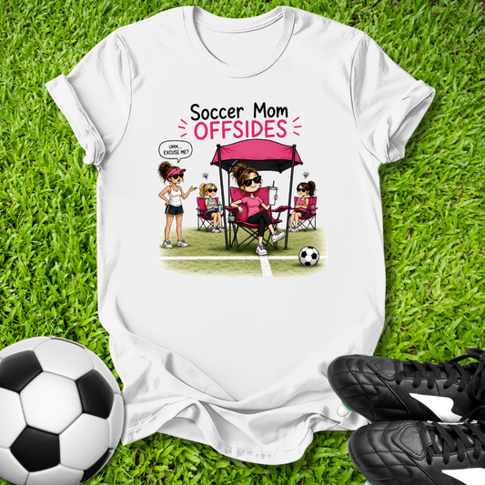 White t-shirt with 'Soccer Mom OFFSIDES' graphic on grass with soccer ball and shoes.
