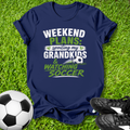Navy blue t-shirt with 'Weekend Plans' text on grass with soccer ball and shoes