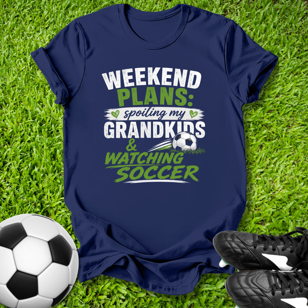 Navy blue t-shirt with 'Weekend Plans' text on grass with soccer ball and shoes