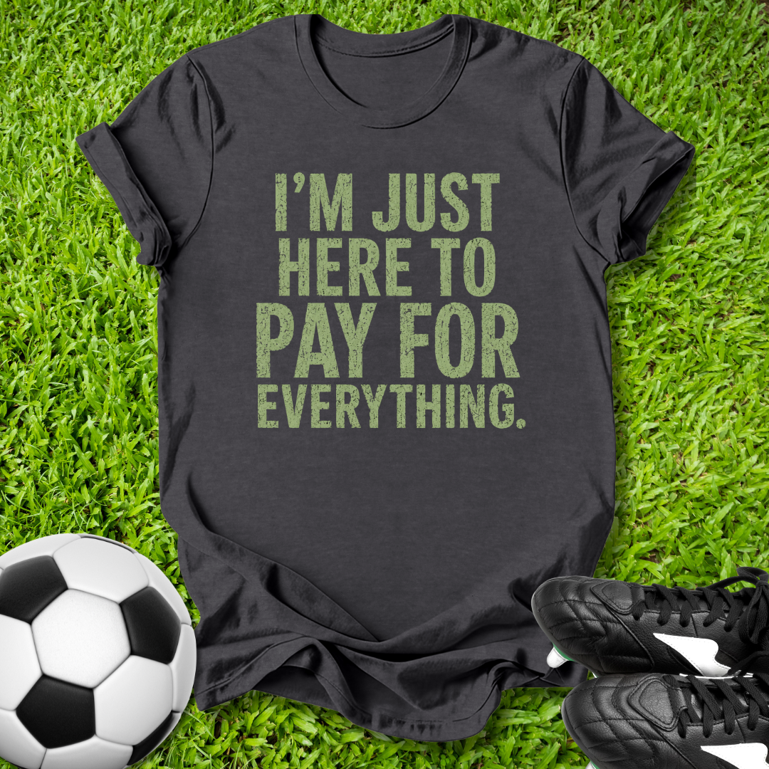 Black t-shirt with humorous text on grass with soccer ball and shoes