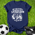 Navy blue t-shirt with graphic and text 'My car is now a locker room' on grass with soccer ball and shoes.