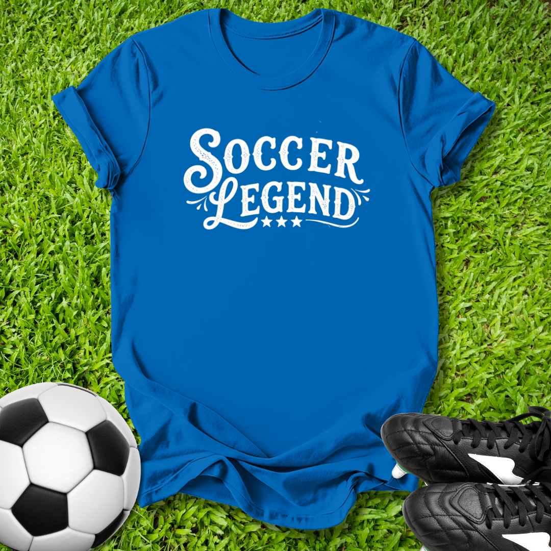 Blue t-shirt with 'Soccer Legend' text on grass with soccer ball and shoes