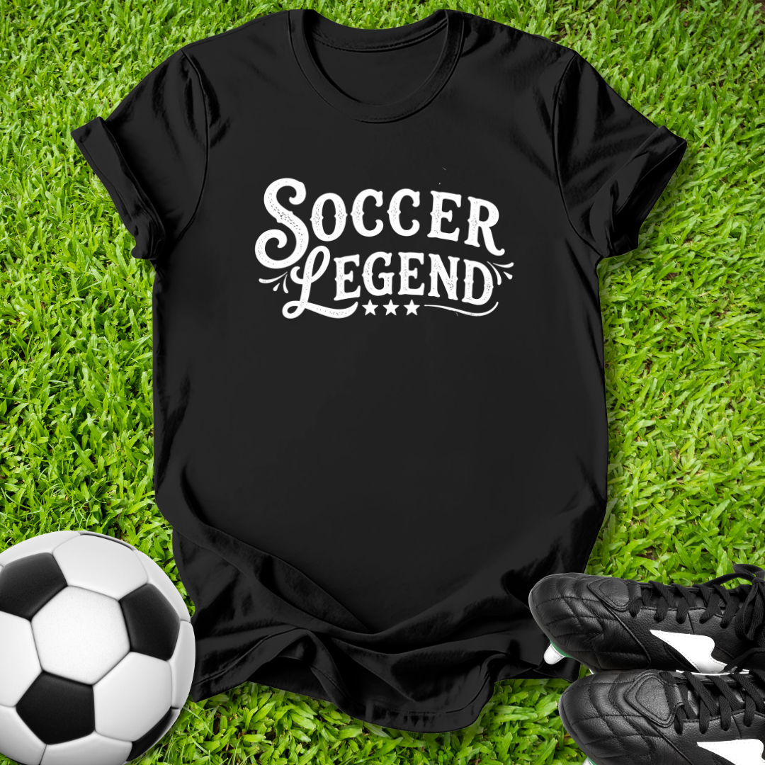 Black t-shirt with 'Soccer Legend' text on grass with soccer ball and shoes