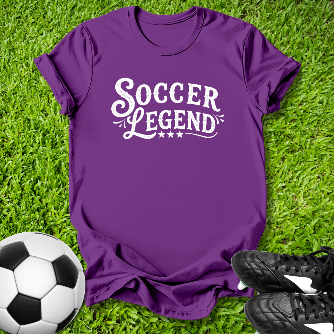 Purple t-shirt with 'Soccer Legend' text on grass with soccer ball and shoes