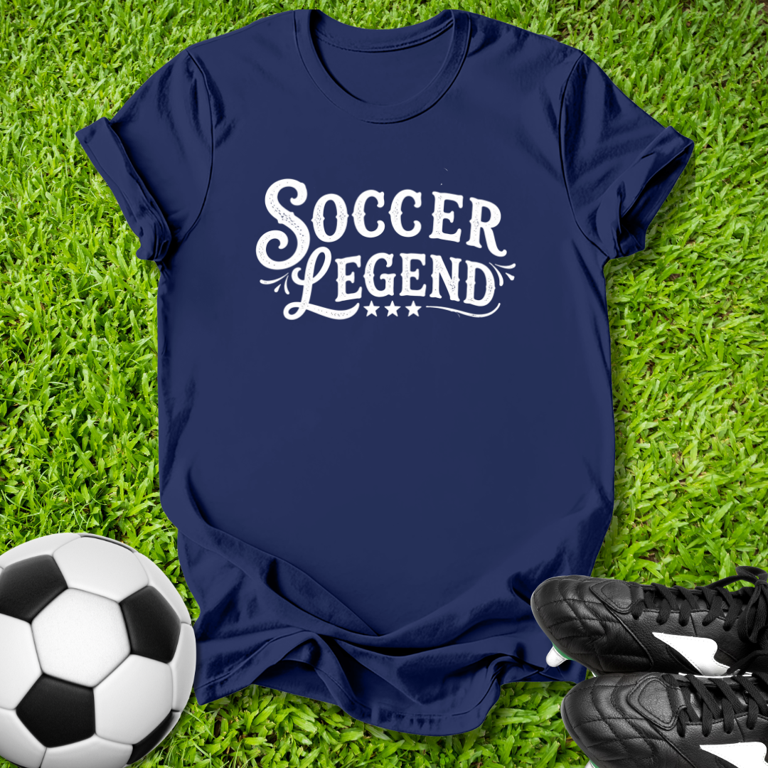 Navy blue t-shirt with 'Soccer Legend' text on grass with soccer ball and shoes.