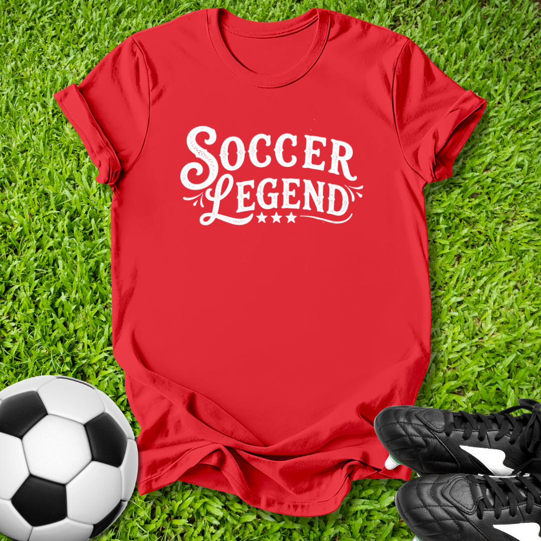 Red t-shirt with 'Soccer Legend' text on grass with soccer ball and shoes