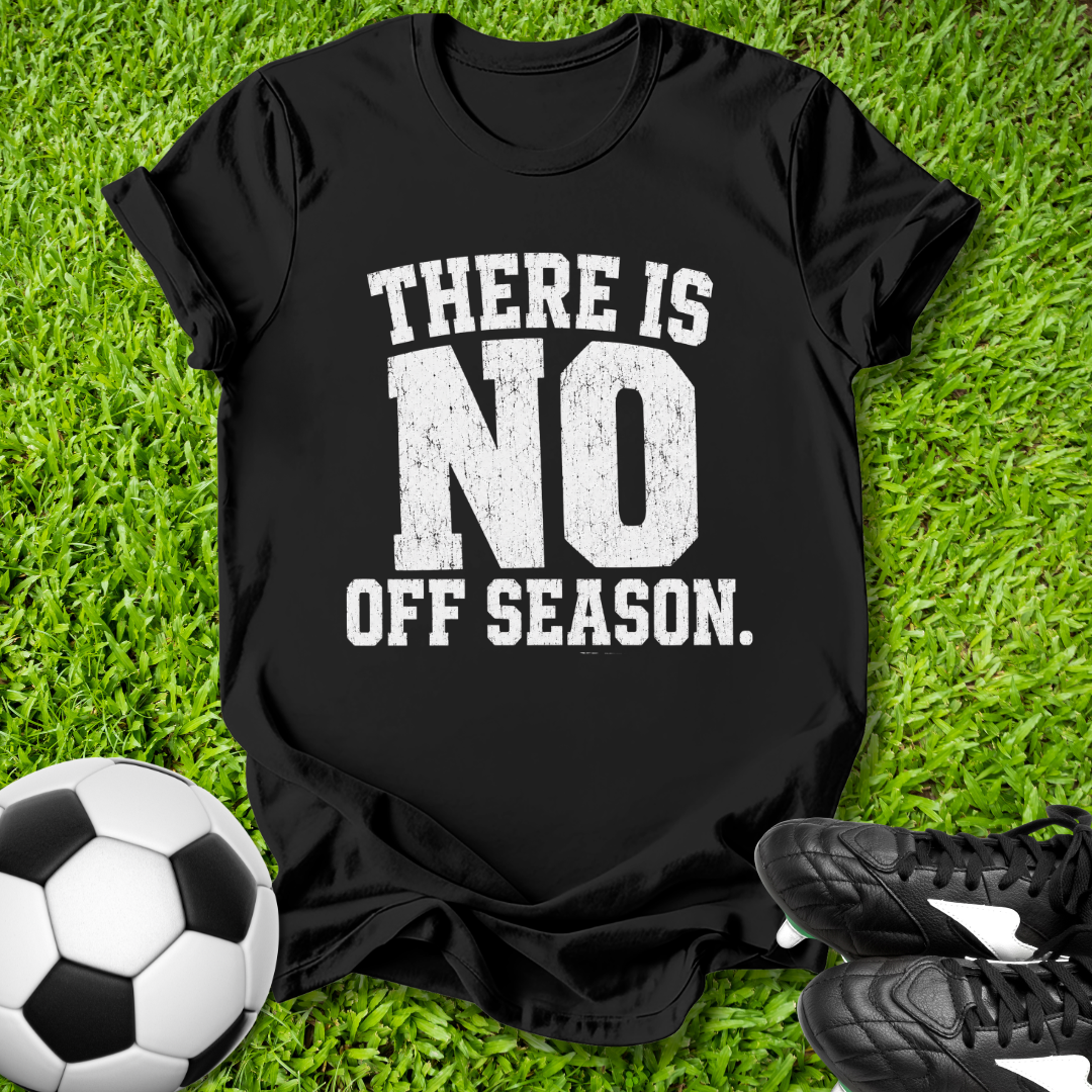 Black t-shirt with 'There is no off season.' text on grass with soccer ball and shoes.